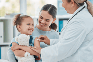 young girl at the doctor with her mother getting a shot, supporting immunization awareness month